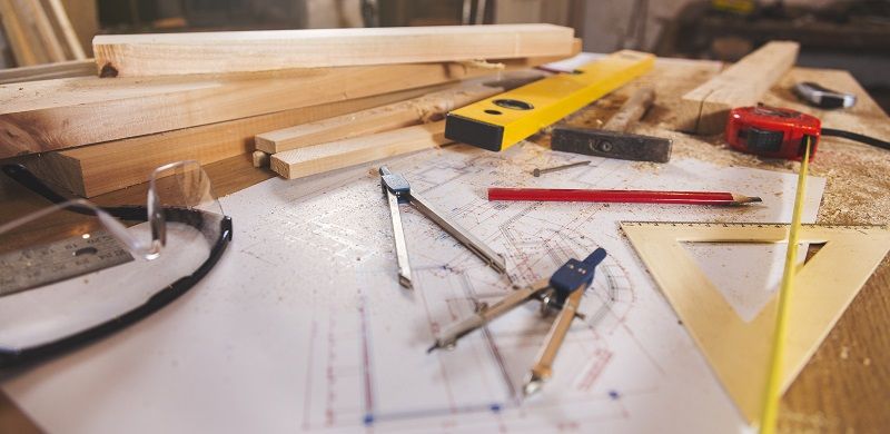 Carpenter tools on wooden background cm