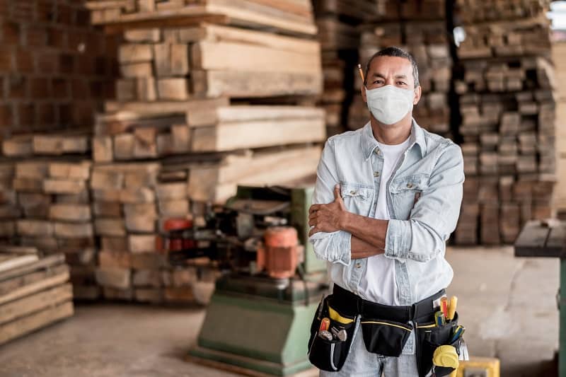 Carpenter working at his workshop wearing a facemask to avoid coronavirus-cm