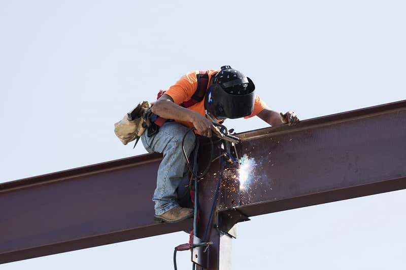 Hispanic ironworker welding a steel girder-cm