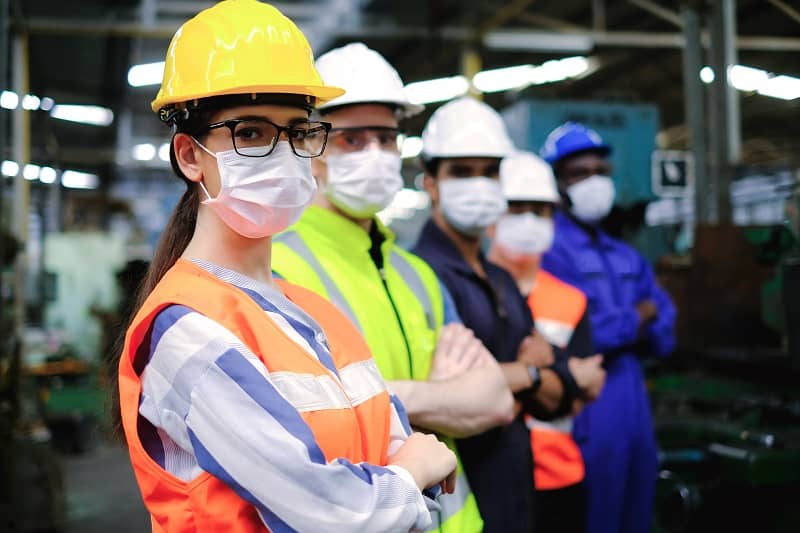 Industrial woman engineer or factory worker wearing helmet and hygiene face mask with teamwork stand in line-c,