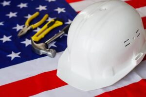 USA flag with helmet and construction tools. Happy Labor day.-cm
