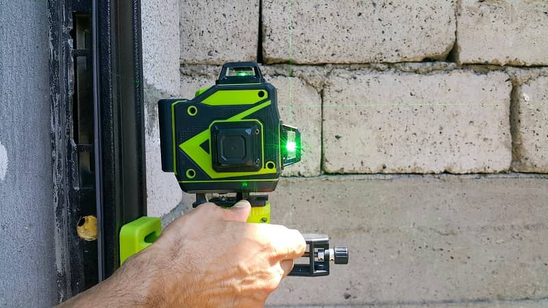 Laser level gauge for measuring green light on a construction site for outdoor construction of a house with masonry walls of a house-cm