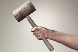 Hand holding wooden mallet-cm