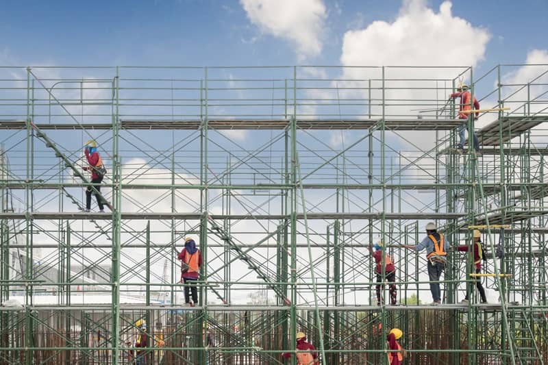 Construction worker on scaffolding in construction site-cm