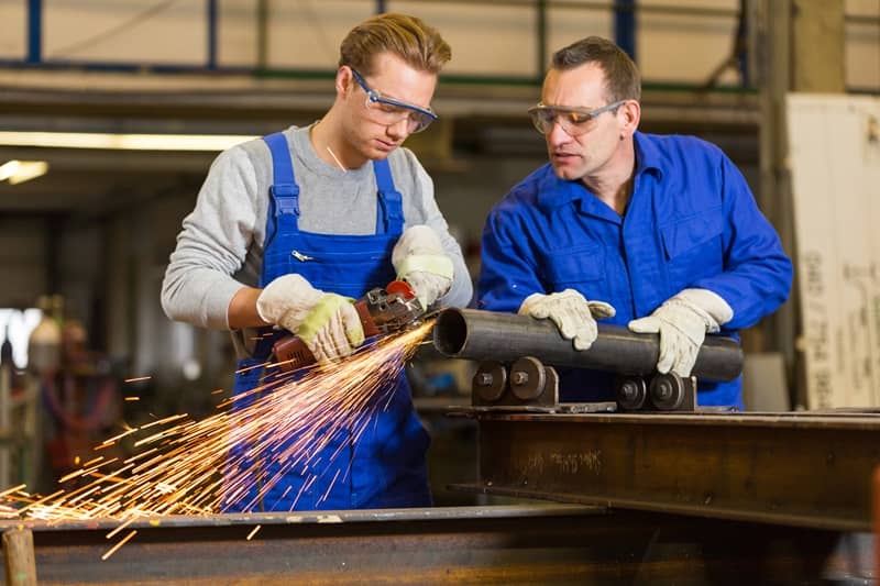 Instructor teaches trainee how to use an angle grinder -cm