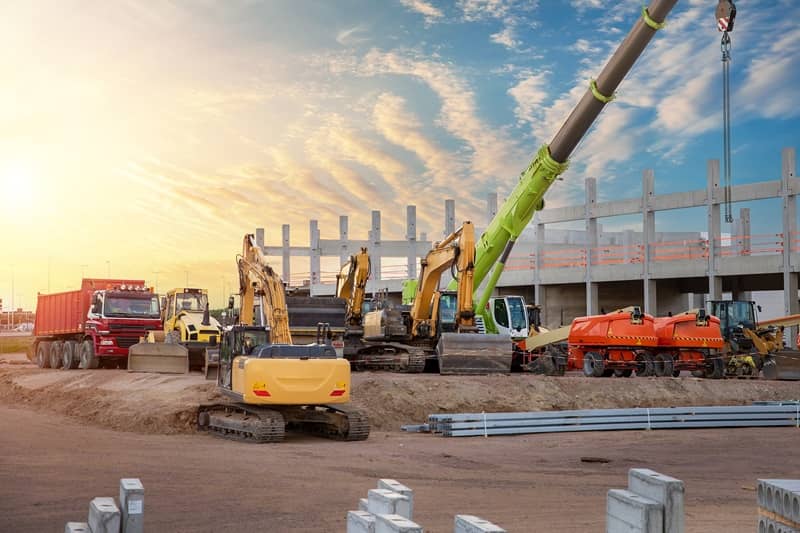 Many different multiclored colorful heavy industrial machinery equipment at construction site parking area -cm