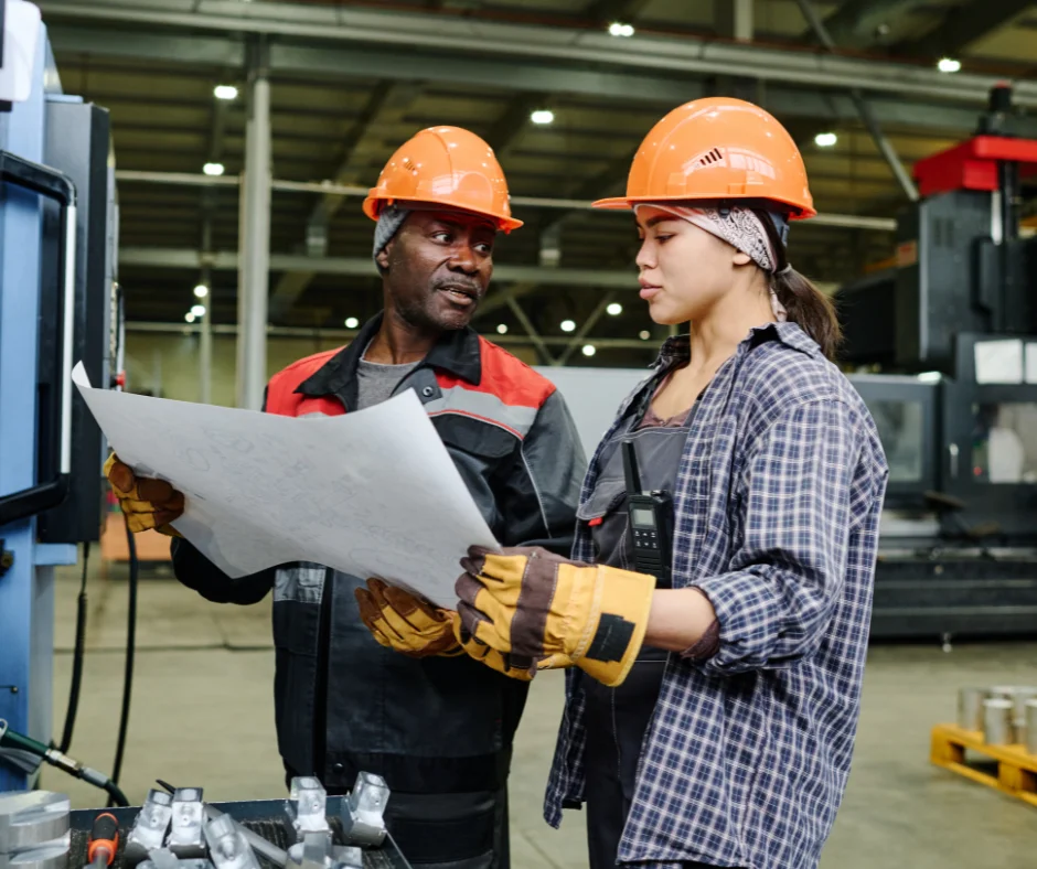 2026 workforce planning in action as skilled industrial workers review project plans on a manufacturing floor
